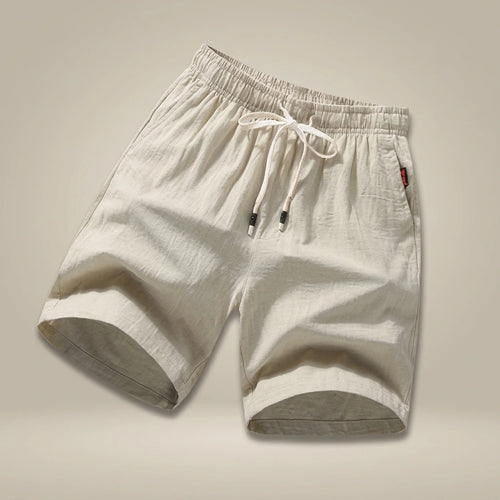 Bermuda Casual Ligera con Jareta Ajustable | Replace only the background of this product photo with a seamless warm greige studio backdrop — a soft neutral tone between light taupe and cream, with a subtle