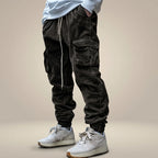 Pantalones Cargo Transpirables Con Cordón en la Cintura | Replace only the background of this product photo with a seamless warm greige studio backdrop — a soft neutral tone between light taupe and cream, with a subtle
